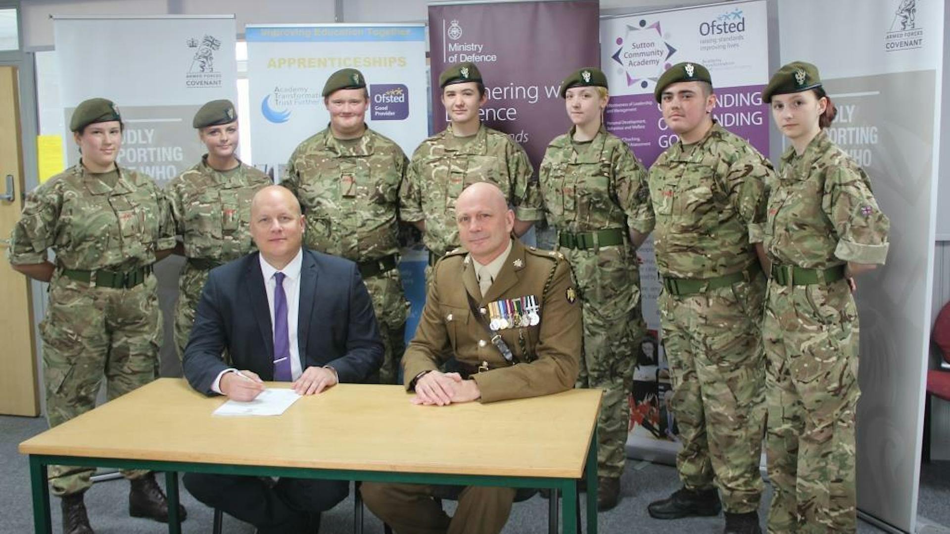 Principal Tim Croft and Lt Col Keith Spiers with cadets from the schools cadet unit 1